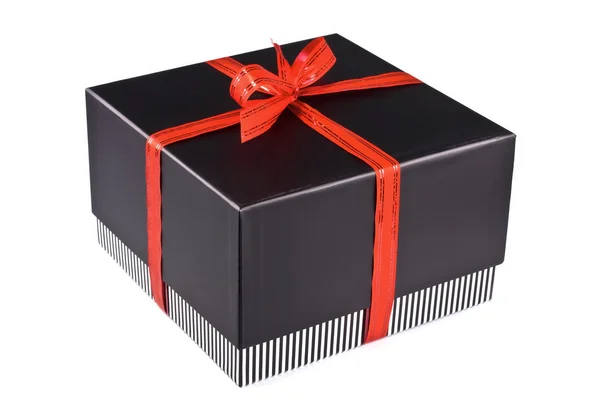Caja de regalo sujeta por una cinta roja —  Fotos de Stock