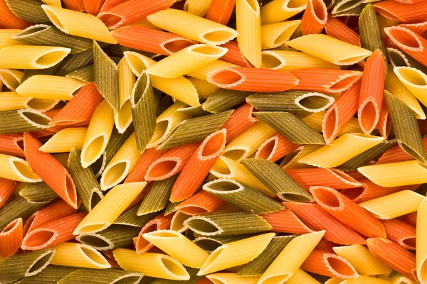 Multi-coloured macaroni, a background — Stock Photo, Image