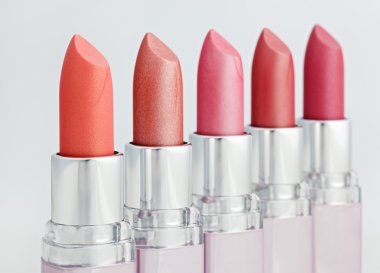 Color lipsticks arranged in line clipart