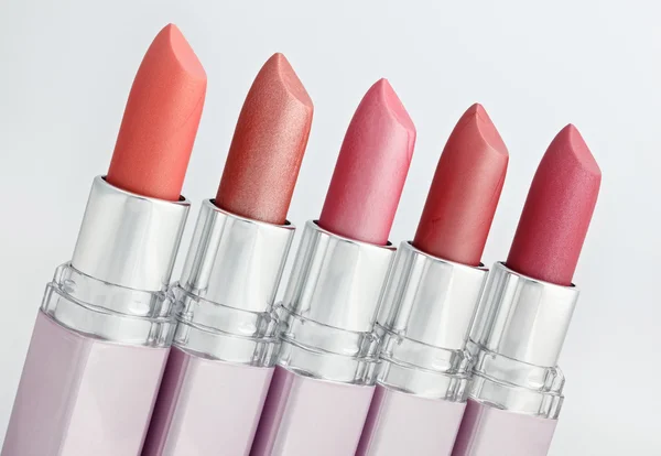 Color lipsticks arranged in line macro — Stok fotoğraf