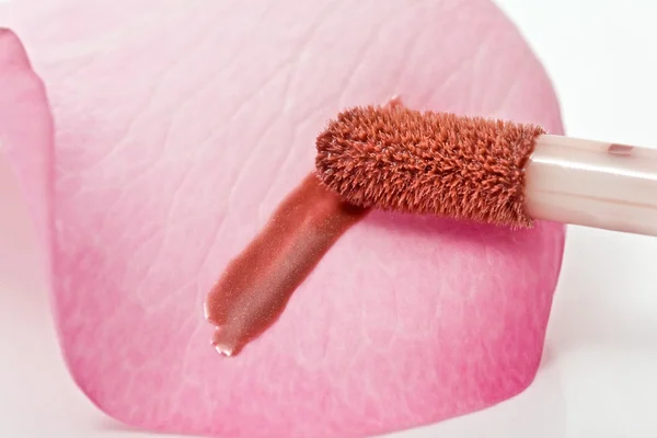 Stroke of gloss lipstick Brush on rose — Stock Photo, Image