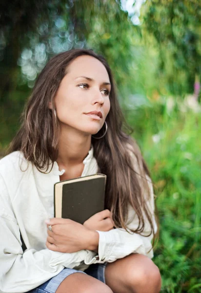 Thoughtful Young lady with book — Stock Photo, Image