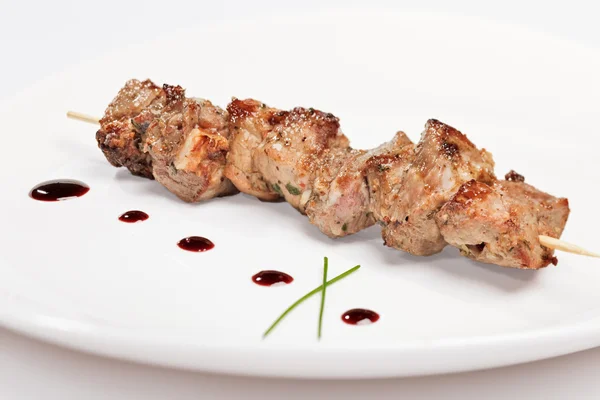 Stock image Pork kebab on white plate