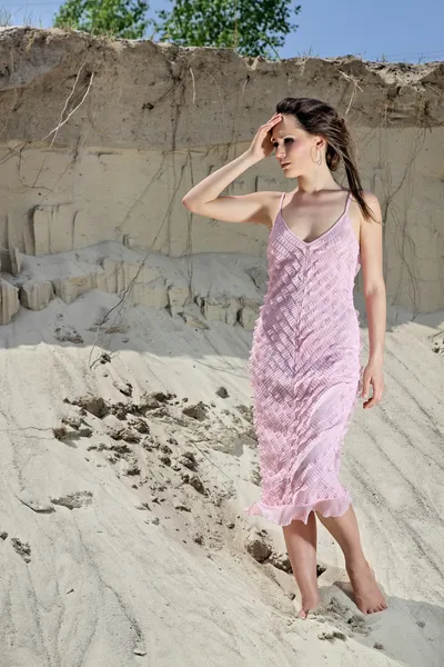 Lady in pink sundress on sand quarry — Stok fotoğraf