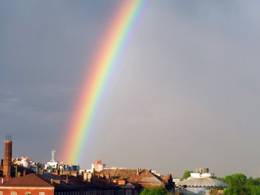 Rainbow multi color image in blue sky clipart