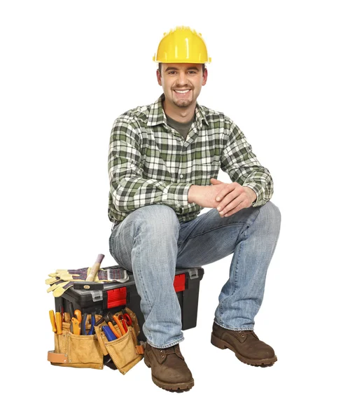 Jovem trabalhador manual e caixa de ferramentas — Fotografia de Stock