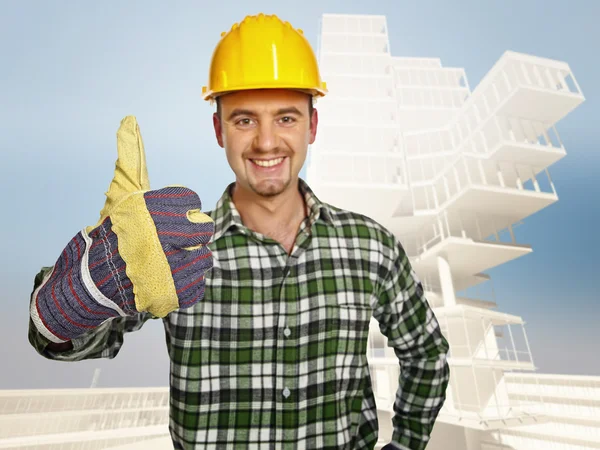 Smiling handyman and building background — Stock Photo, Image