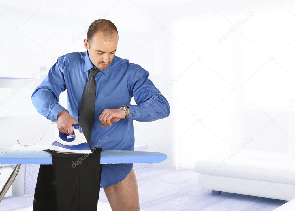 Businessman ironing his trouser