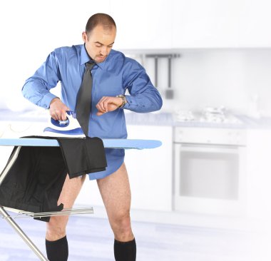 Businessman ironing his trouser clipart