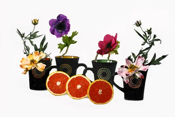 Schwarze Tassen und Blumen — Stockfoto