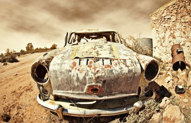 Old car in the desert clipart