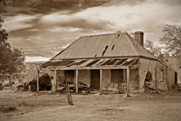 Old farmhouse ruins in sepia — Stock Photo, Image