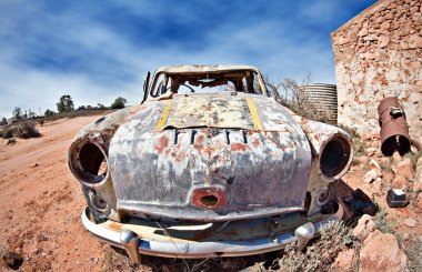 Old car in the desert clipart