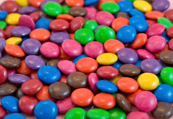 Fundo pilha de smarties chocolates — Fotografia de Stock