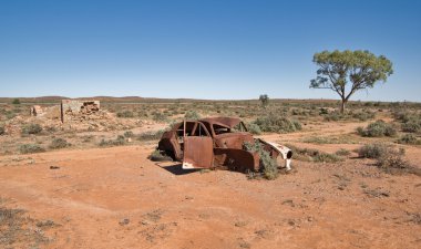 Old car in the desert clipart