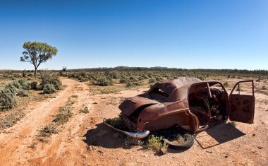 Old car in the desert clipart