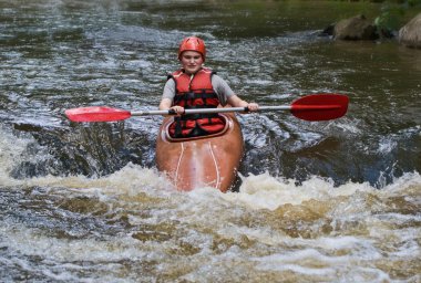 Teenage girl white water kayaking clipart