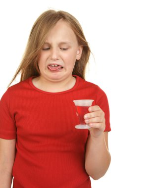 Young girl taking medicine clipart