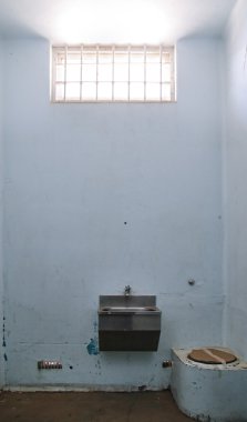 Old prison cell with barred window clipart