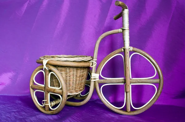 Wooden bicycle on a violet background — Stock Photo, Image