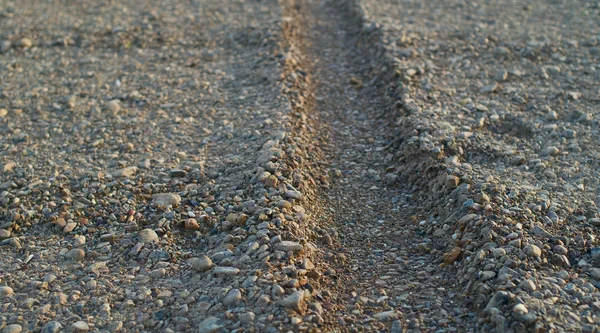 Traces from wheels on stony soil — Stock Photo, Image