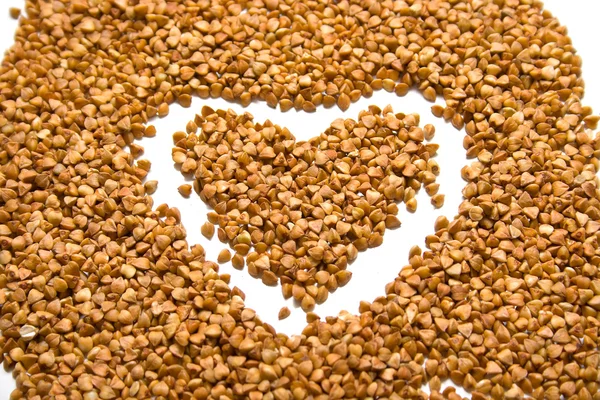 Heart on buckwheat groats — Stock Photo, Image