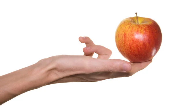 Červené jablko v mužské ruce — Stock fotografie