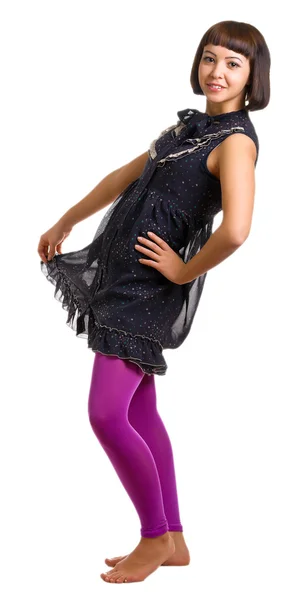 Meisje in een donkere jurk en lila kousen — Stockfoto