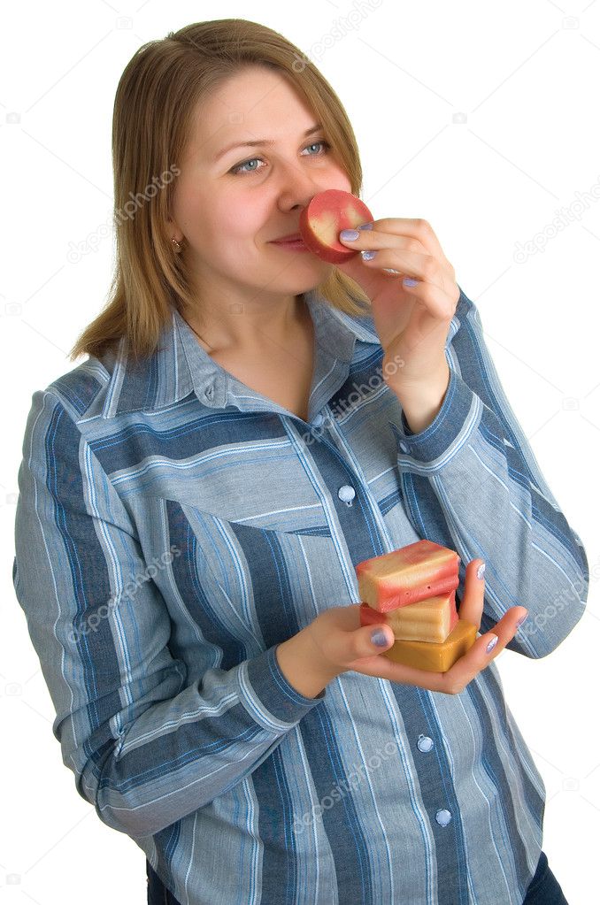 Woman smells a soap slice in hand