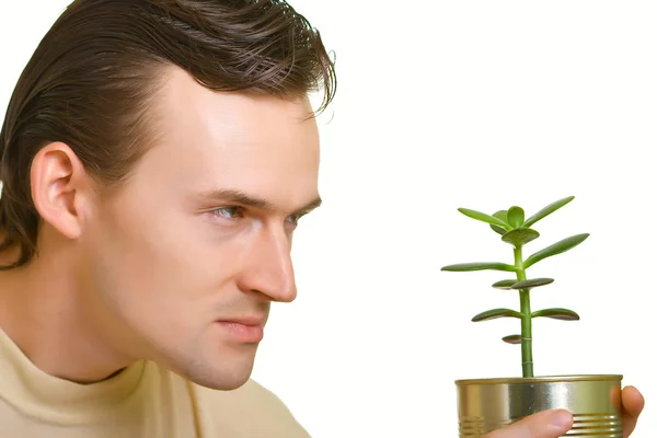 Man looks at a plant — Stock Photo, Image
