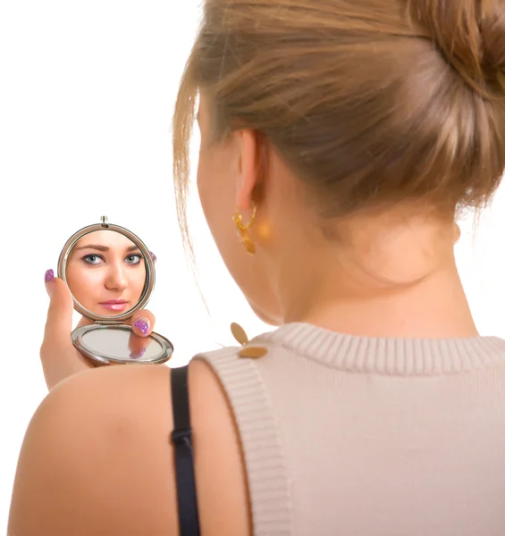 Women looks in a mirror — Stock Photo, Image