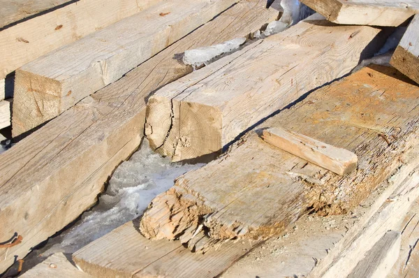 stock image Old boards are snow-capped