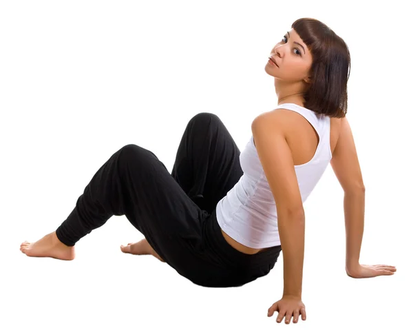 Sitting girl in sportswear on a white — Stock Photo, Image