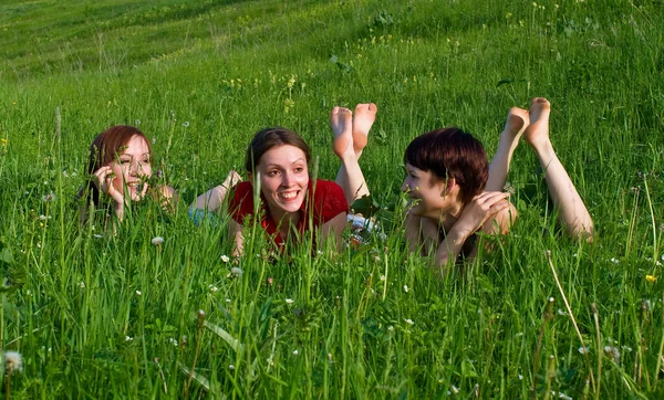 Girls lay in a green grass — Stock Photo, Image