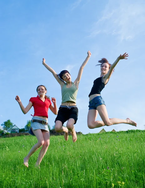 Girls jump on the meadow — Stock Photo, Image