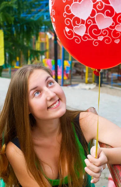 Joyful girl with balloons in park — Stock Photo, Image