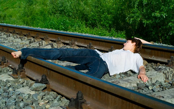 Young girl laying on a railway — Stock Photo, Image