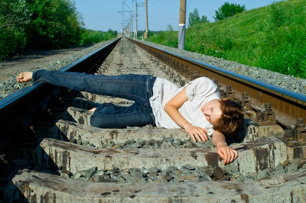 Mädchen liegt auf einer Eisenbahn — Stockfoto