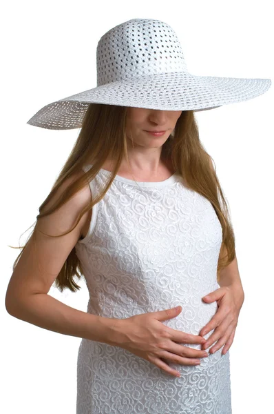 Těhotné ženy v bílém klobouku a šaty — Stock fotografie