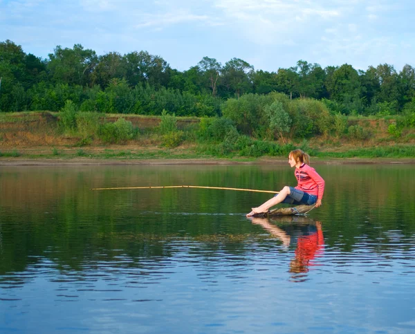 Chica-pescador se sienta en un tronco —  Fotos de Stock