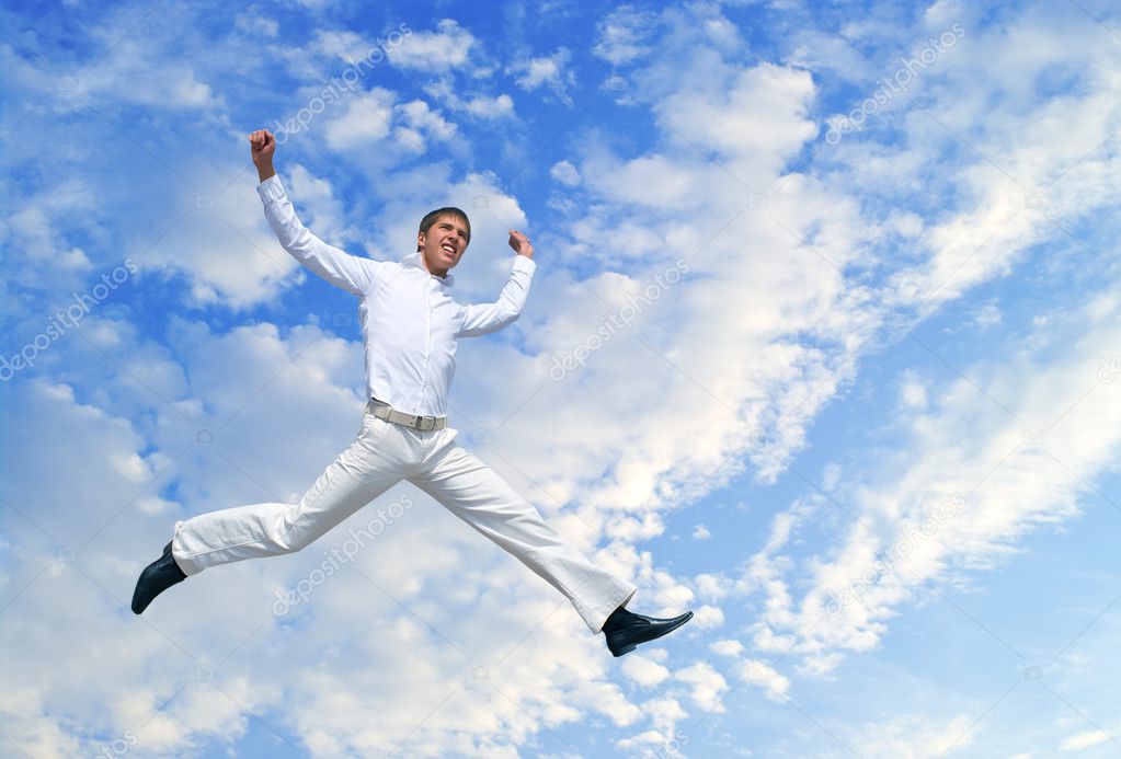 Men jumping against blue sky