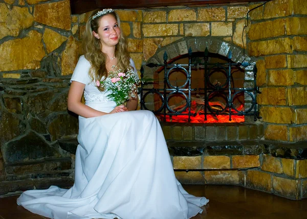 Bride against fireplace — Stock Photo, Image