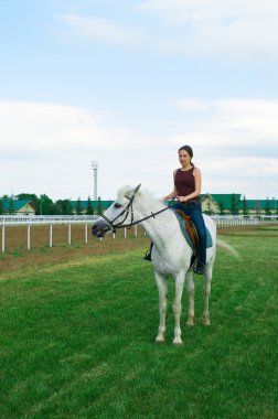 Girl astride a horse clipart