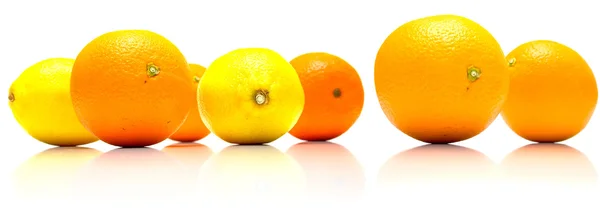 Целые апельсины и желтые лимоны — стоковое фото