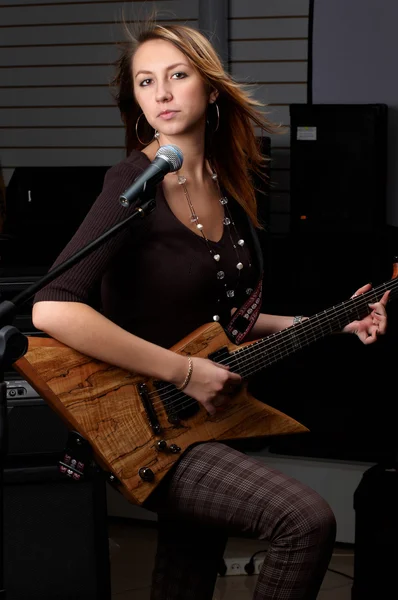 Flicka med gitarr amd mikrofon — Stockfoto