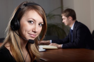 Young female talk by headset with microphone in clipart