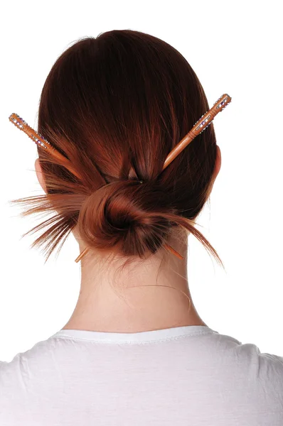 Coupe de cheveux fille avec deux bâtons en bois — Photo