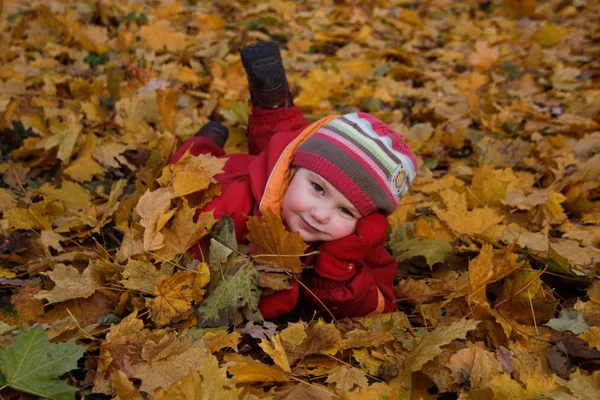 stock image Happy girl lying on autumn leaves