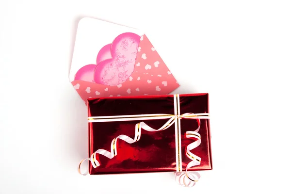 Pink packet and red box with gift — Stock Photo, Image