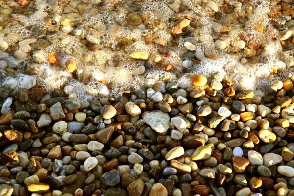 Gravel stones and foam background — Stock Photo, Image
